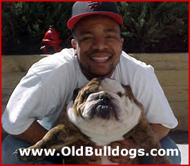 KWAME WINSTON HOLDING HIS ENGLISH BULLDOG